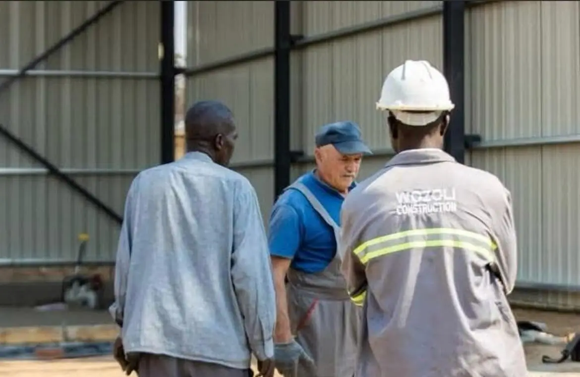 Wozoli Construction site team in branded worksuits on an industrial build
